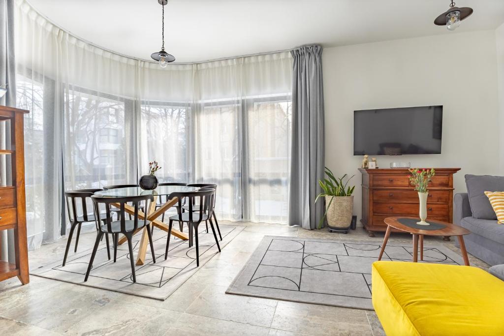 a living room with a table and chairs and a couch at Baltivia Haus II in Gdynia
