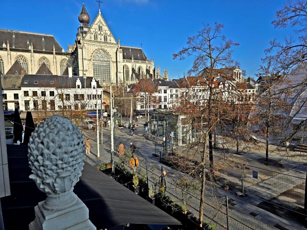 a view of a city with a statue in the foreground at GuestHouse Groenplaats in Antwerp