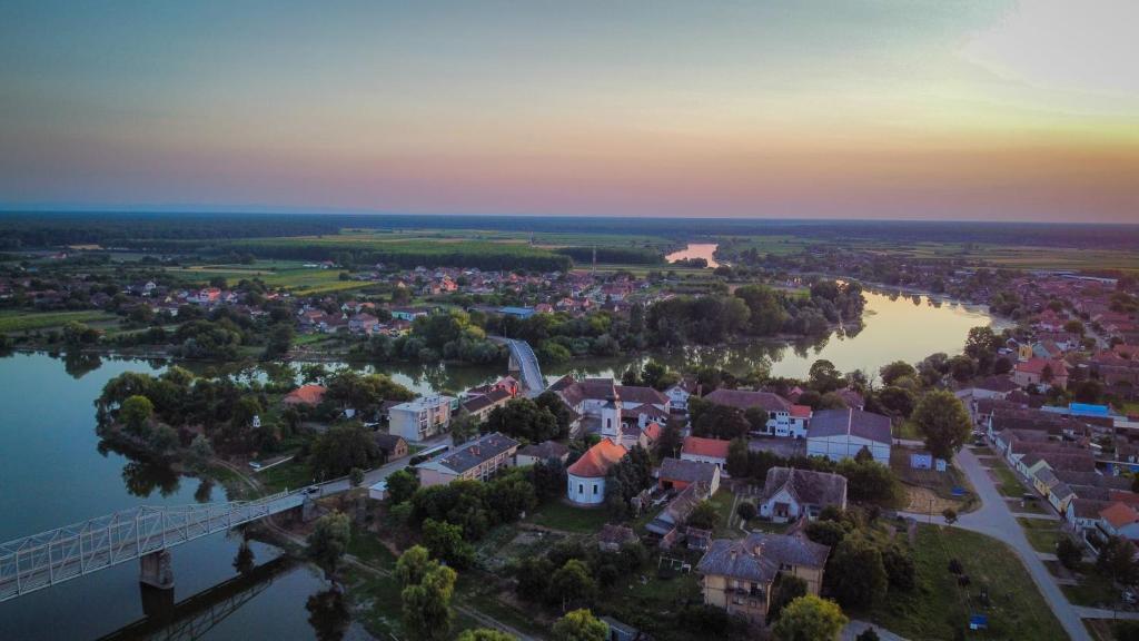an aerial view of a town with a bridge over a river at "Poetsko ćoše" Nikole Tesle 86 in Morović