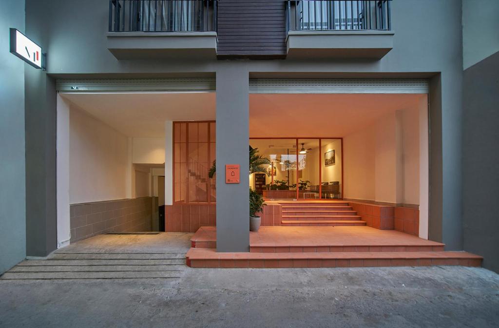 a lobby of a building with stairs and a hallway at Express by M Village Lê Văn Sỹ, a brand of Modern Village Lifestyle in Ho Chi Minh City