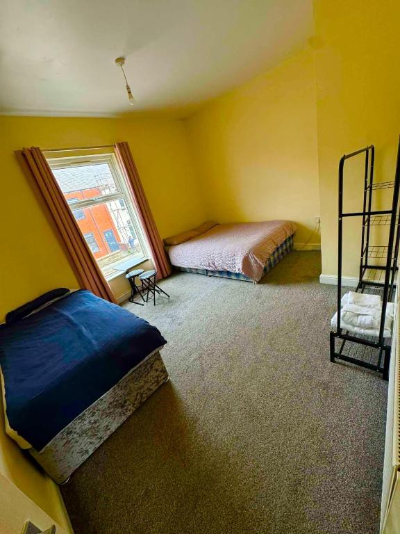 a bedroom with two beds and a window at Babo room in Farnworth