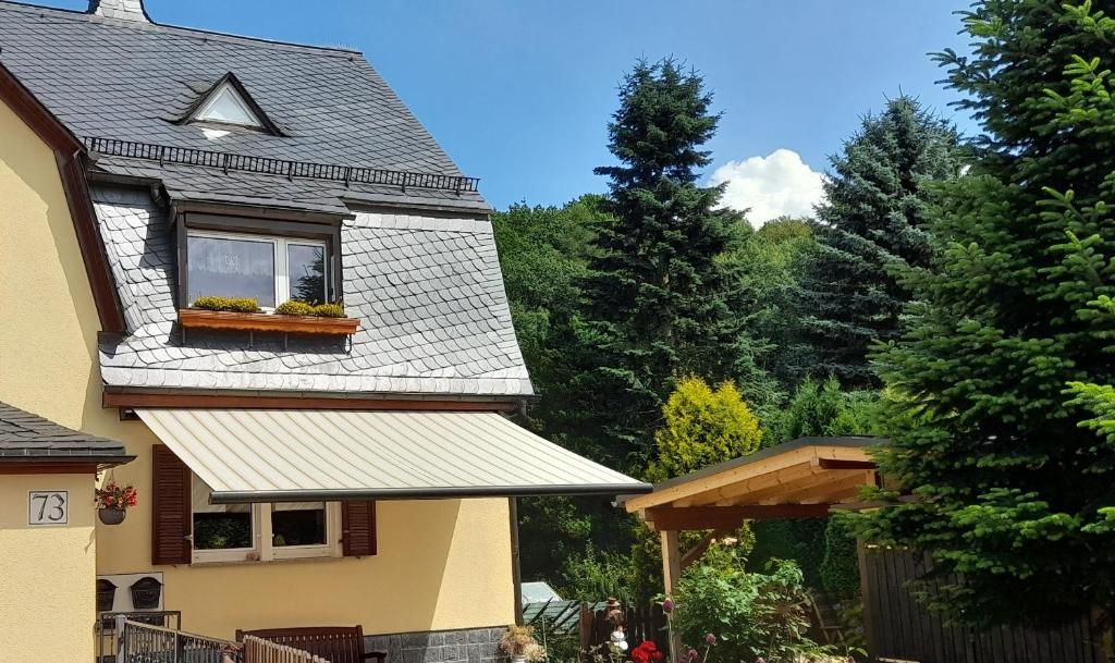 a house with a window with a flower box on it at Mansardenwohnung Waldblick in Lichtenstein