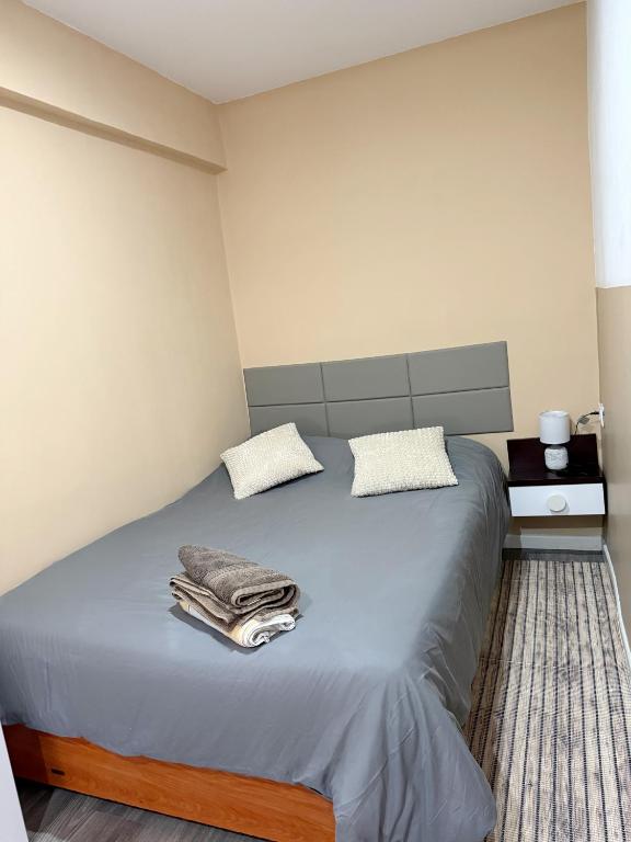 a bedroom with a bed with towels on it at Avenue Rooms in Valencia