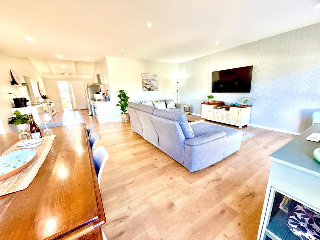 a living room with a couch and a table at Goolwa Blue Escape - Beach Spacious Wi-fi in Goolwa