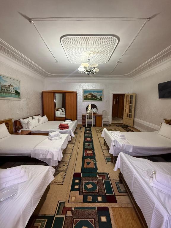 a room with a bunch of beds in it at BUKHARA Air Hostel in Bukhara