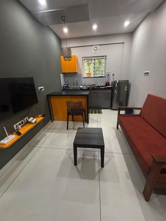 a living room with a couch and a table at G10 & 12 - Sabari Enclave Premium One bedroom Apartment in Trivandrum