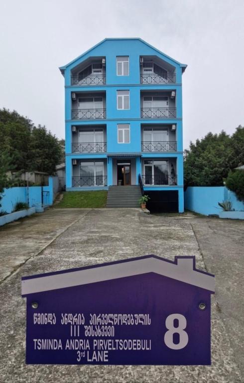 a blue building with a sign in front of it at Rio Gonio in Gonio