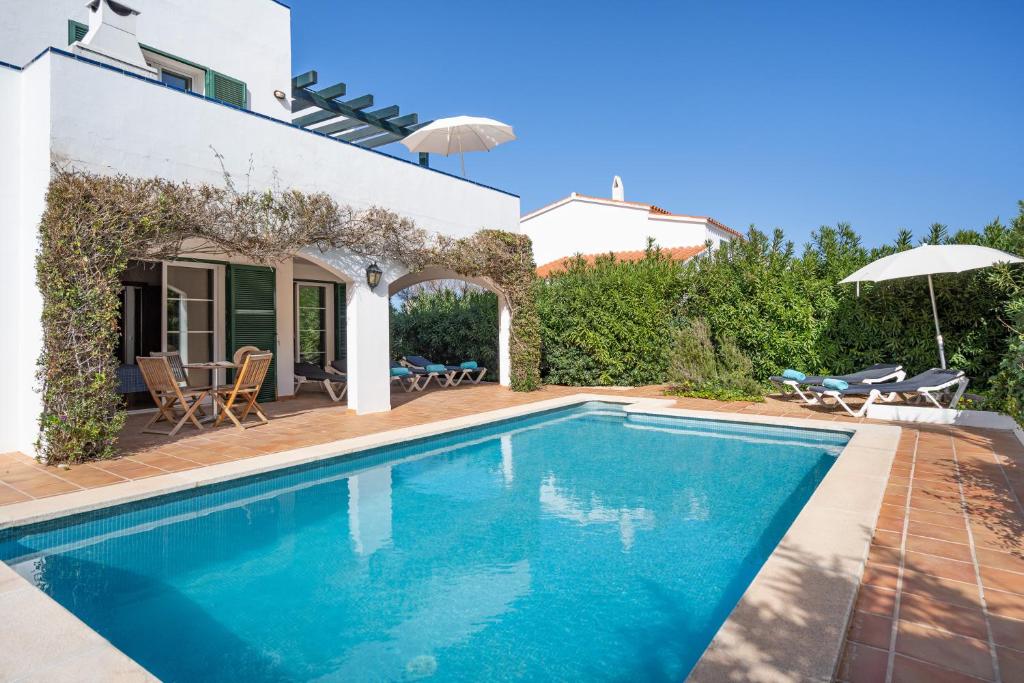a swimming pool in the backyard of a villa at Villa Sea Garden Holidays by 3VILLAS in Port d'Addaia