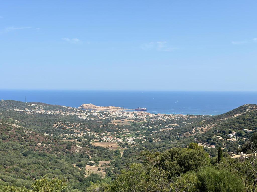 a view of a valley with trees and the ocean at Casa Sant'Antone in Santa-Reparata-di-Balagna