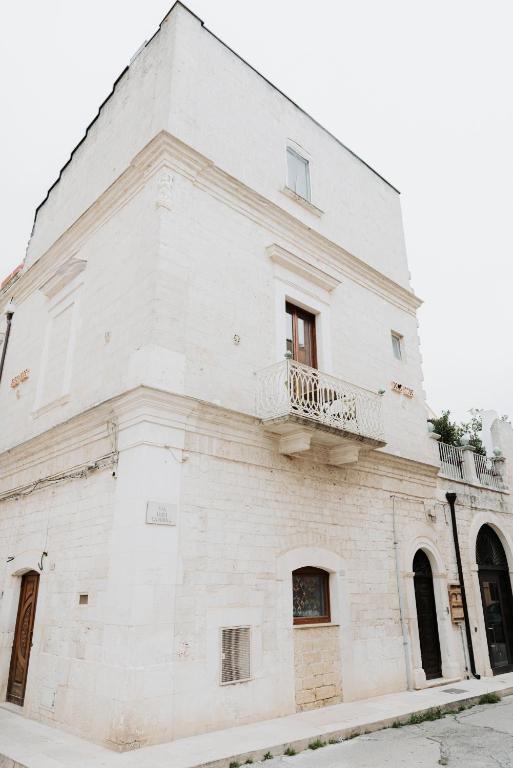 a white building with a balcony on the side of it at Palazzo Mimì in Bitritto