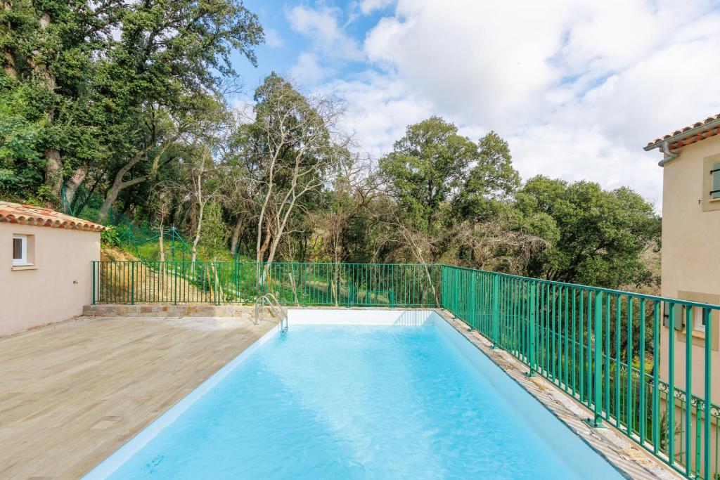 a swimming pool in the backyard of a house at Féeries Provençales YourHostHelper in Grimaud