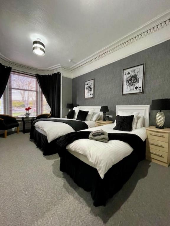 a large bedroom with three beds in it at Vaila Guest House in Aberdeen