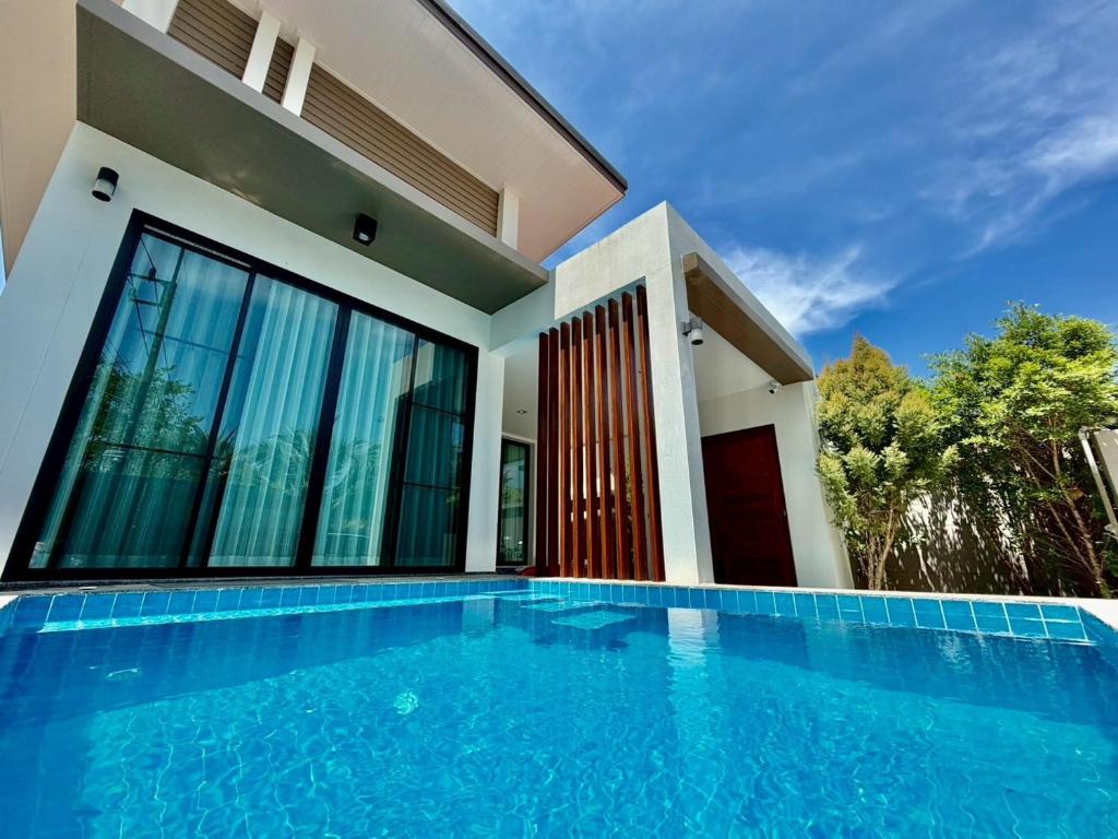 a house with a swimming pool in front of a house at Bestest Pool Villa in Krabi