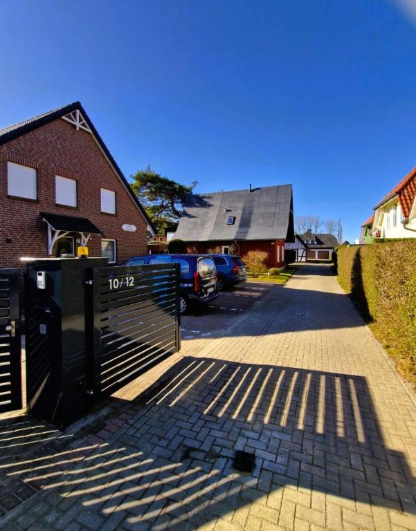 a driveway with a house and a car parked in front at Haegerende _Alte Liebe_ in Groß Kirr