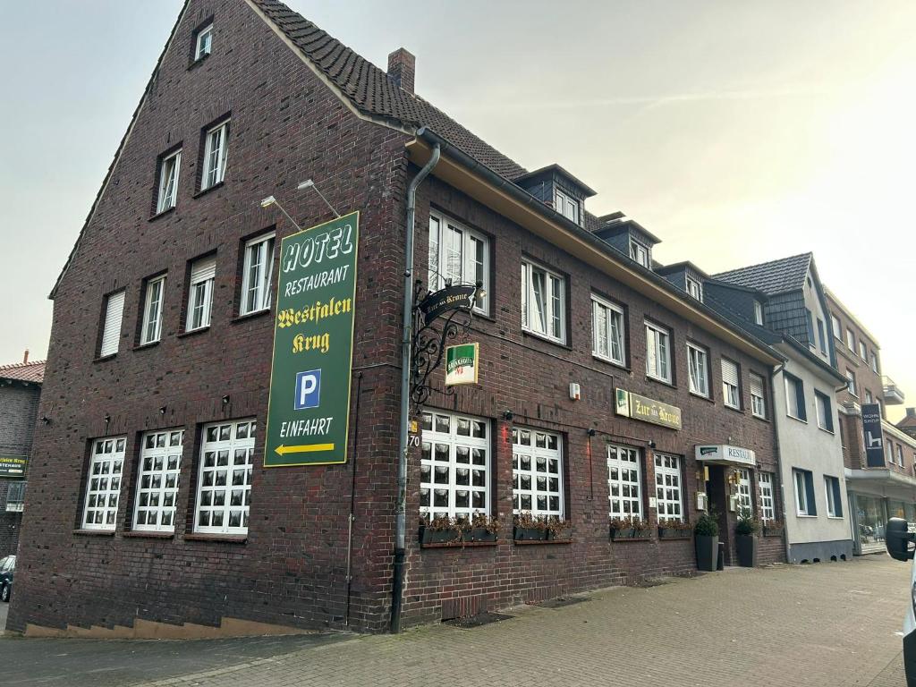 a brick building with a parking sign in front of it at TM Hotel Westfalen in Lünen