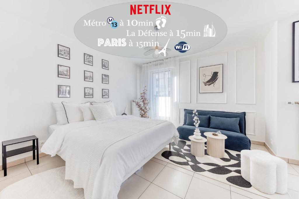 a white bedroom with a bed and a blue chair at L'Écrin Piano, chic near Paris in Asnières-sur-Seine