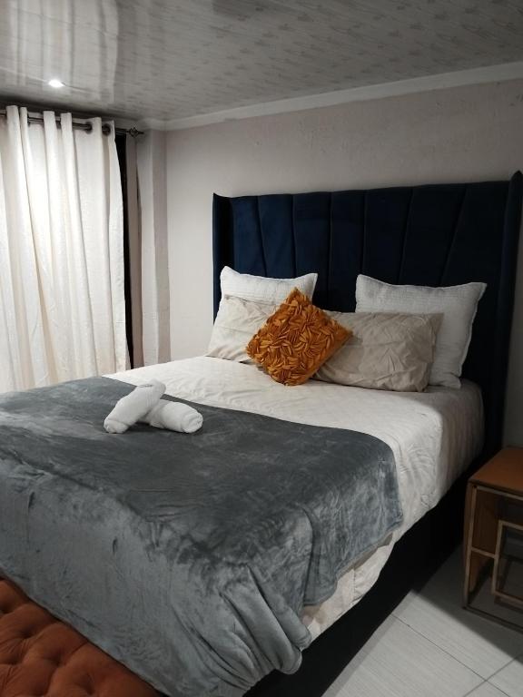 a bed with two stuffed animals on top of it at Soshanguve Lux Accom Room 03 in Soshanguve