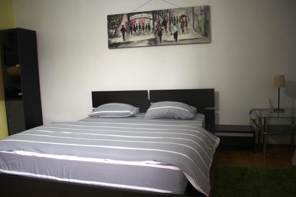 a bedroom with a large white bed with two pillows at decebal premium apartment in Bucharest