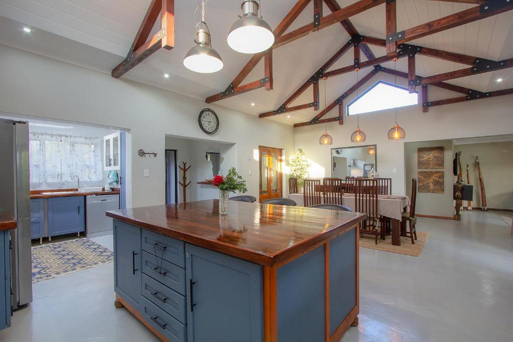 a kitchen with a large island in the middle of a room at White Sparrow Villa in Marloth Park