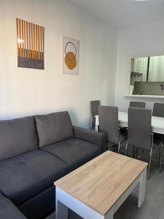 a living room with a couch and a table at LUZ DEL MAR Almuñécar Centro Playa in Almuñécar