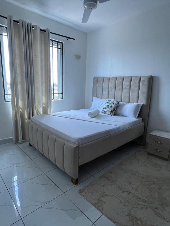 a bed in a bedroom with a large mattress at Skyview Bamburi Suites in Mombasa