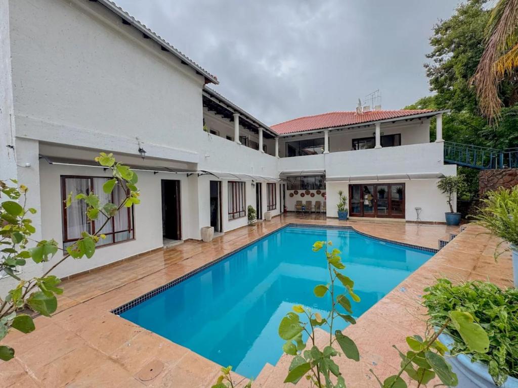 an image of a villa with a swimming pool at Miyanwe Guest House - Waterkloof in Pretoria