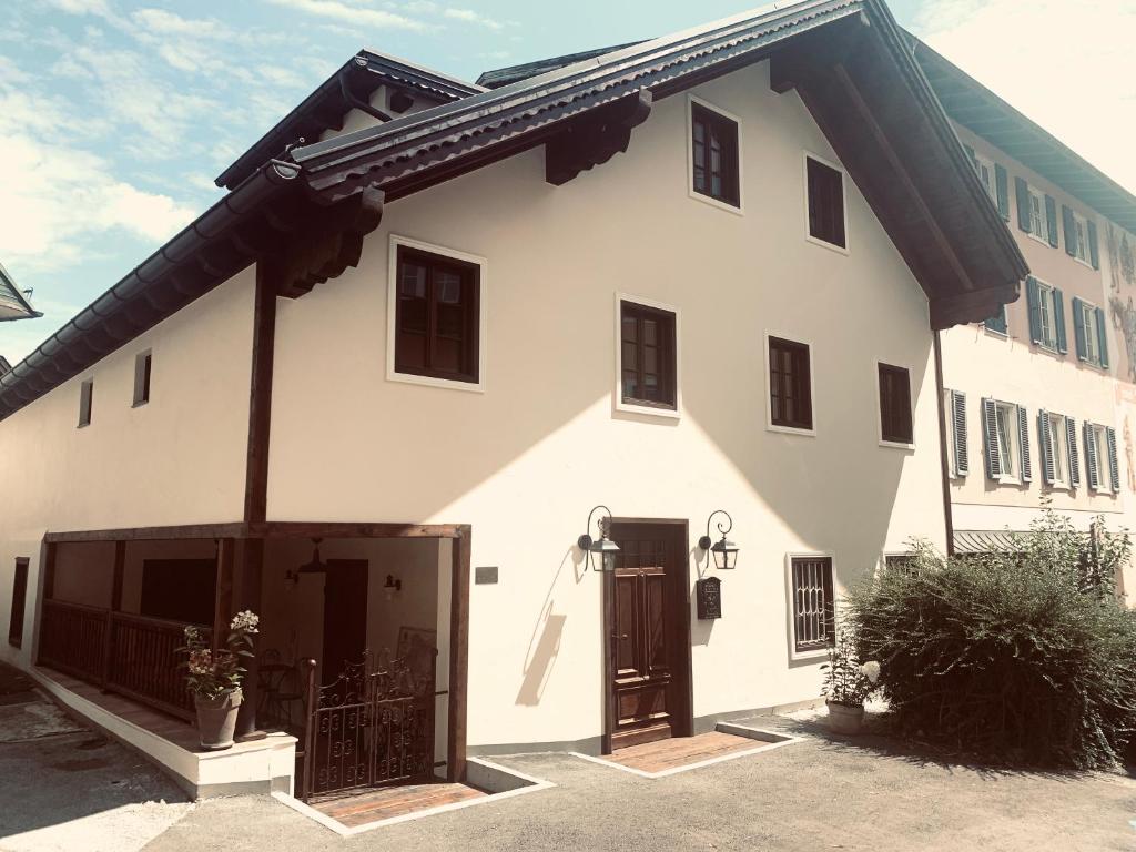 a large white building with a large garage at undfein boutique studios in Sankt Gilgen