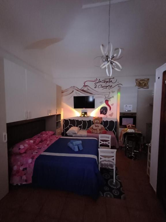 a bedroom with a large bed and a ceiling fan at la casetta di ciacione piazza del plebiscito in Naples