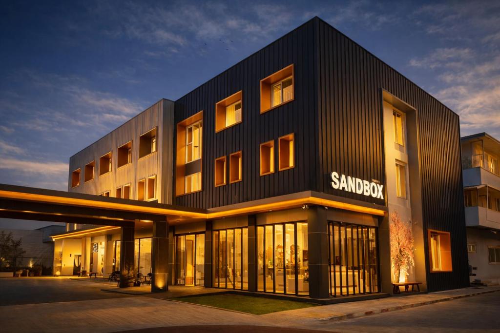 a building with a sanchez sign on the side of it at โรงแรมแซนด์บอกซ์ นครศรีธรรมราช in Nakhon Si Thammarat