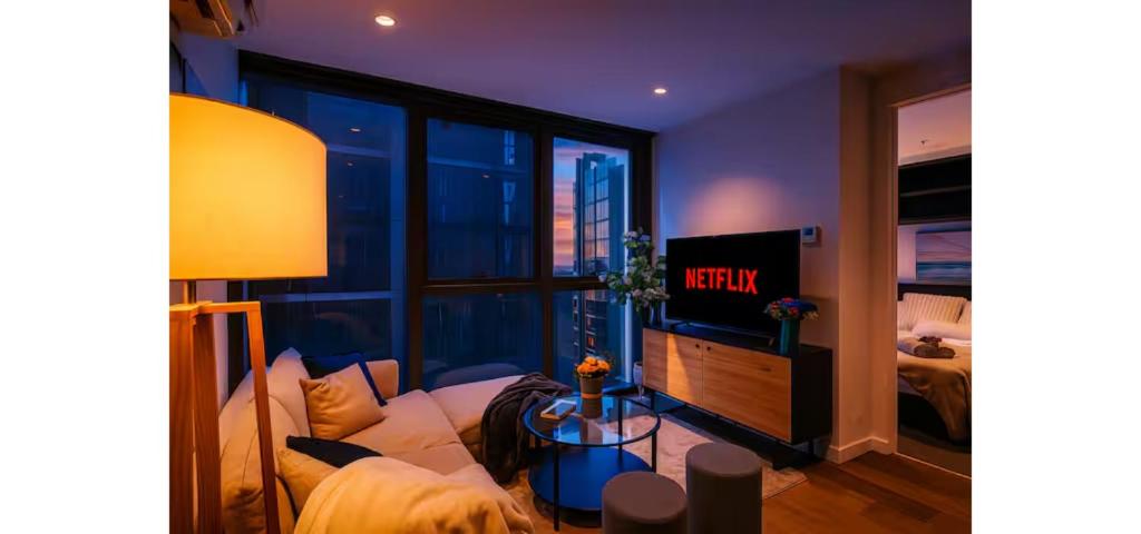 a living room with a couch and a window at Luxe 46th Level 2 Bedroom CBD Apartment with Pool Gym Spa and Views in Melbourne