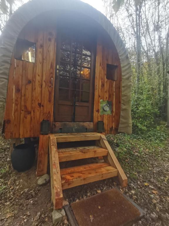 a wooden cabin with a porch in a dome at La Verdine in Lacaze