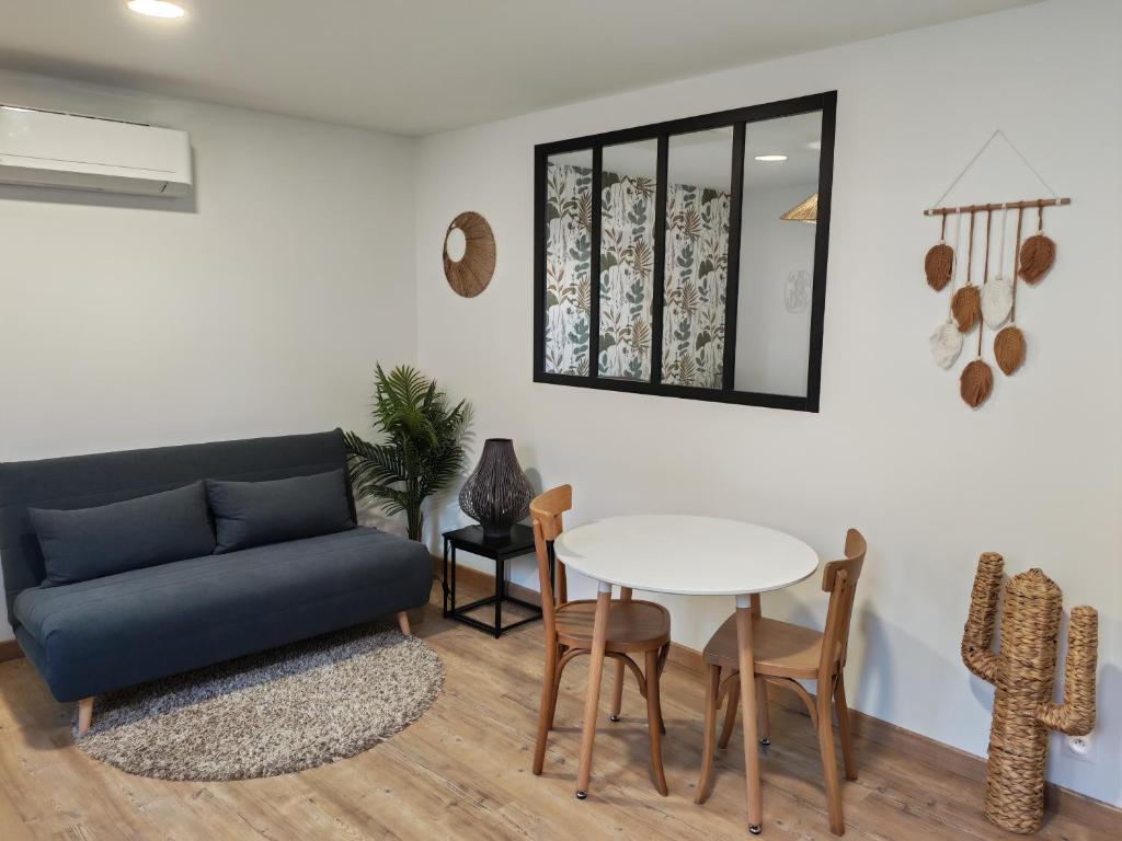 a living room with a couch and a table at Roger's appartement in Larrivière