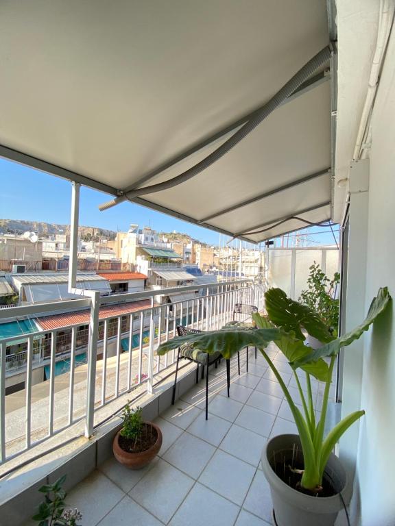 a balcony with a view of a building at Top Floor Apt with Balcony - Acropolis View & Sunset - Koukaki in Athens