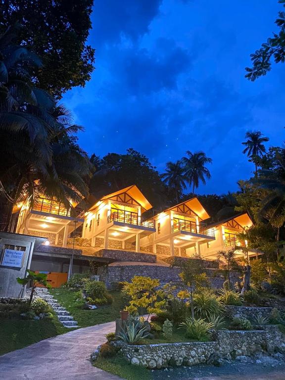 a resort building with lights on at night at Island Garden Beach Resort in Samal