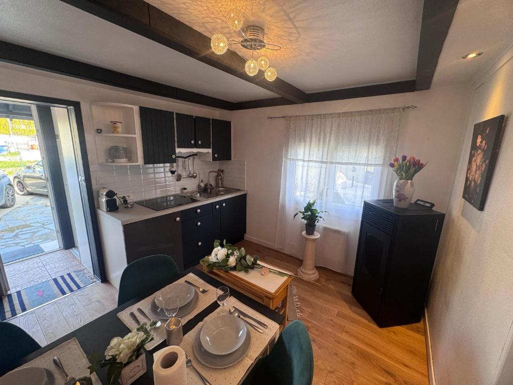 a living room with a table and a kitchen at Stephan house in Tremblay-En-France
