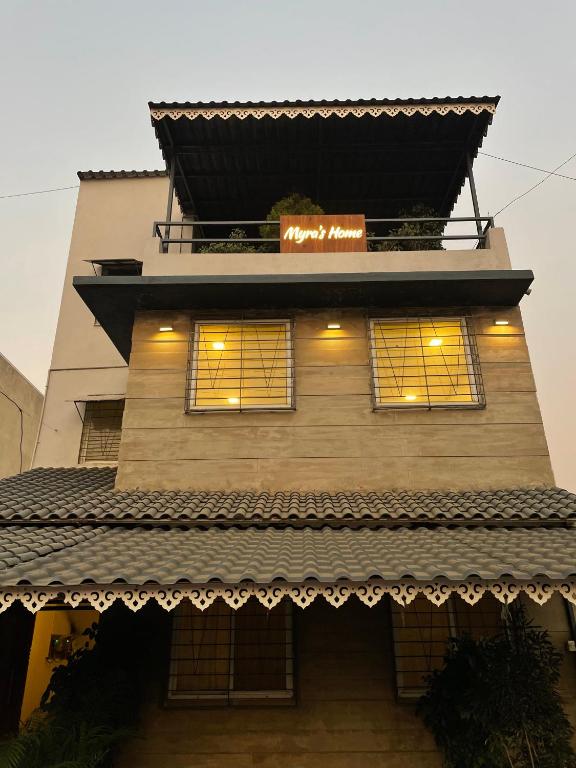 a building with a sign on top of it at Myra Villa Kolhapur Entire Private Home in Kolhapur