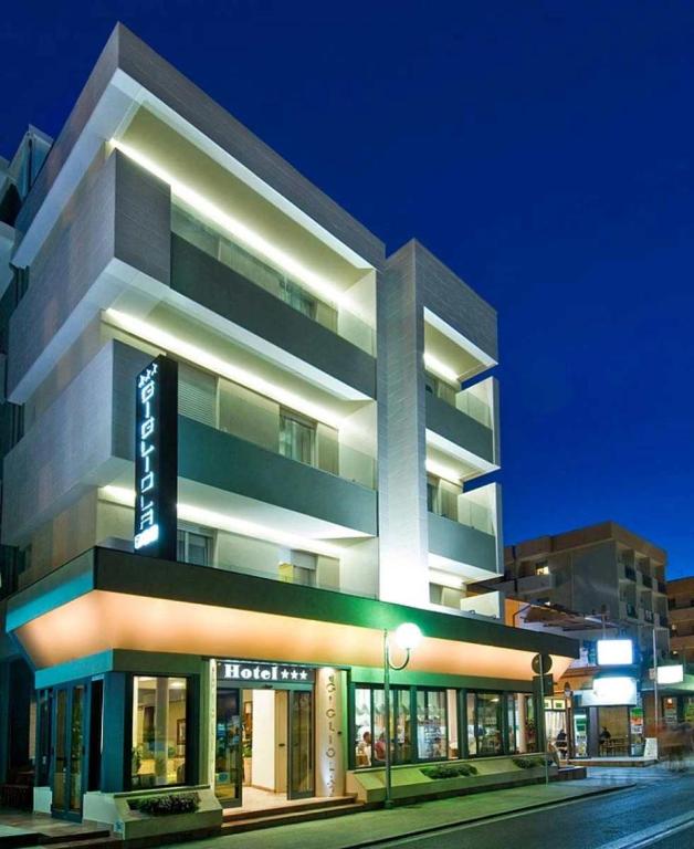 a large building with a sign on the side of it at Hotel Gigliola in Bellaria-Igea Marina
