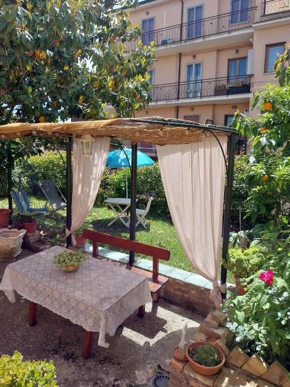a gazebo with a table in a garden at Eden casa vacanze in Morlupo