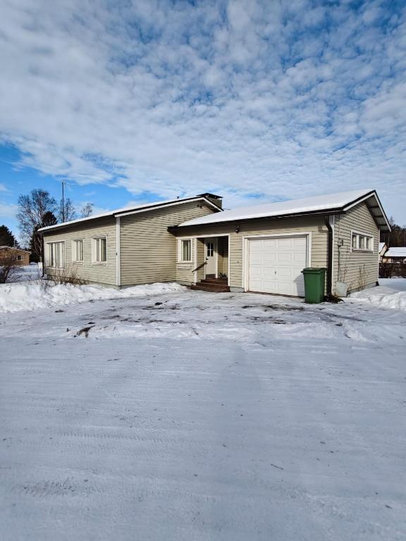 a house with a lot of snow in front of it at Simple Cozy House in Raahe