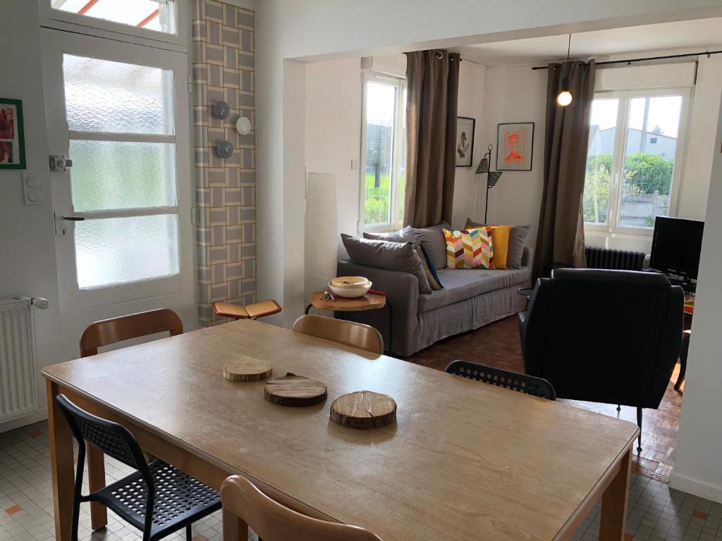 a living room with a table and a couch at 10 Courchamp in Courchamp