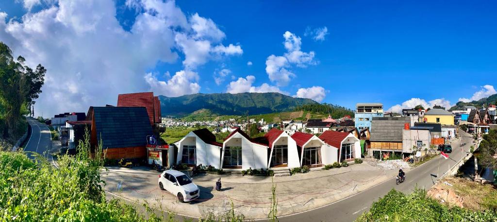 a small town with a white car parked in the street at Glamping Calla in Banjarnegara