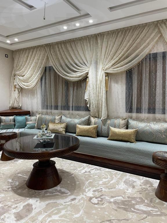 a living room with a couch and a table at Fes Golf Residence in Fez