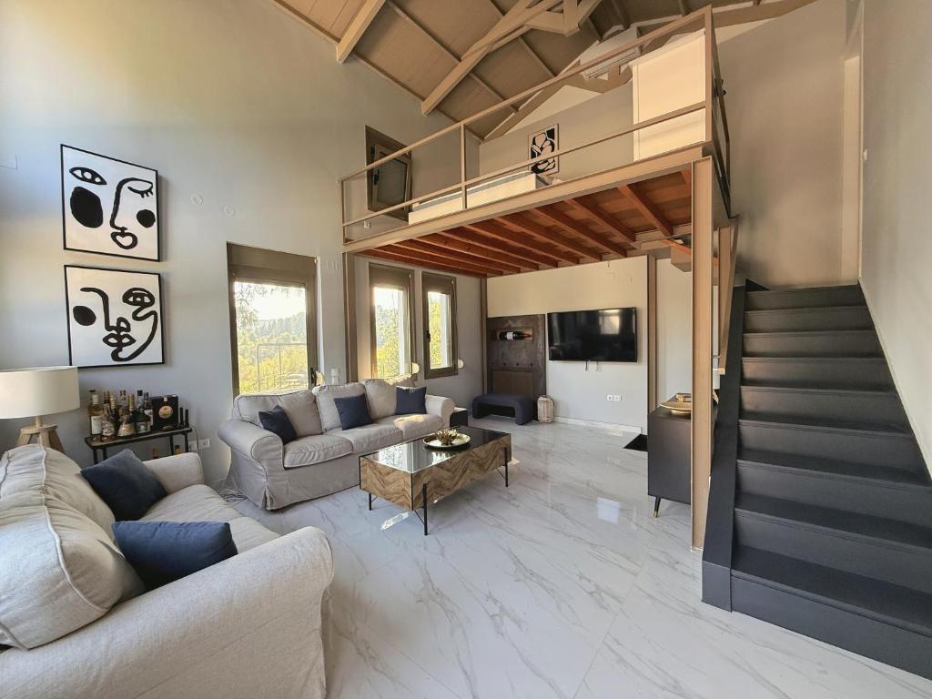 a living room with a couch and a loft at Cassa Luca in Glarokavmos in Paliouri