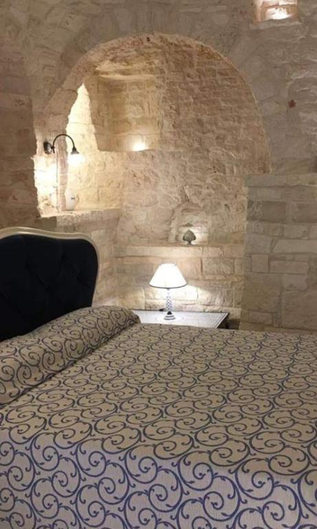 a bedroom with a bed in a stone wall at RODRIGUEZ Luxury Suite in Ostuni