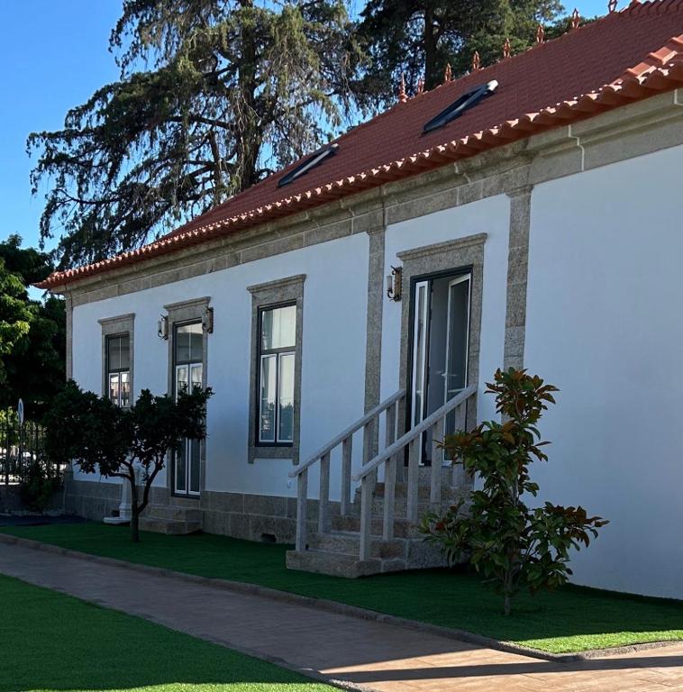 a white house with a red roof at O Cantinho da Cotovia in Valpaços