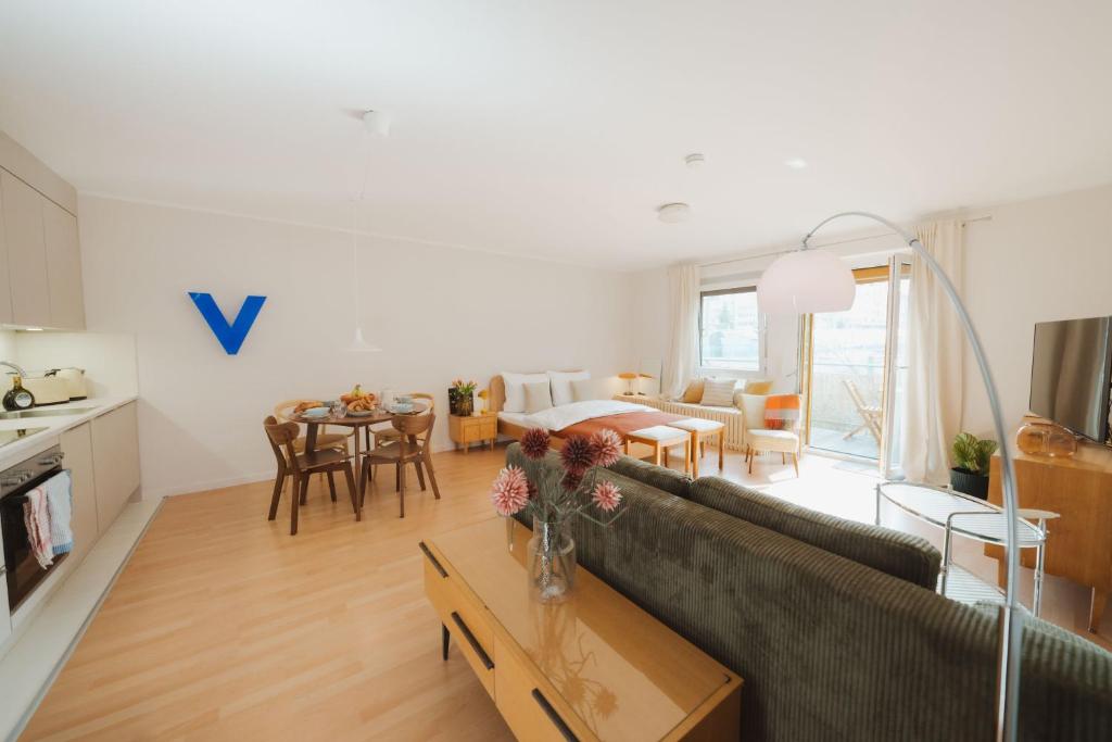 a living room with a couch and a table at Studio5 am Ringpark in Würzburg