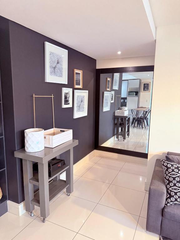 a living room with a table and a couch at Finagaello 3 bedrooms-Self catering at 77 on Independence in Windhoek
