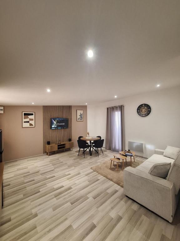 a living room with a couch and a table at L'escale du Chemin des Dames in Cerny-en-Laonnois