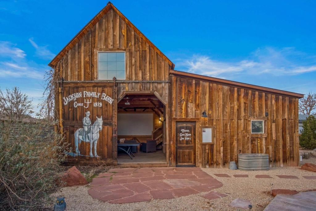 a large wooden barn with a large door at Timber & Tin F 2Bed 2Bath w Pool & Rooftop Deck in Kanab