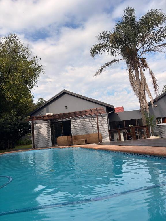 a large swimming pool in front of a house at 101 Marais Villa in Hartbeespoort